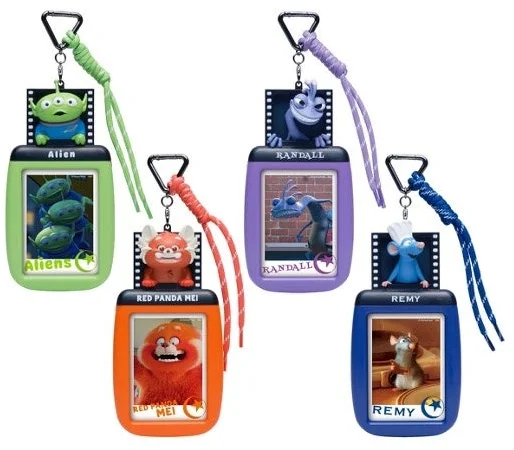 A card holder with a small character figure attached to the top