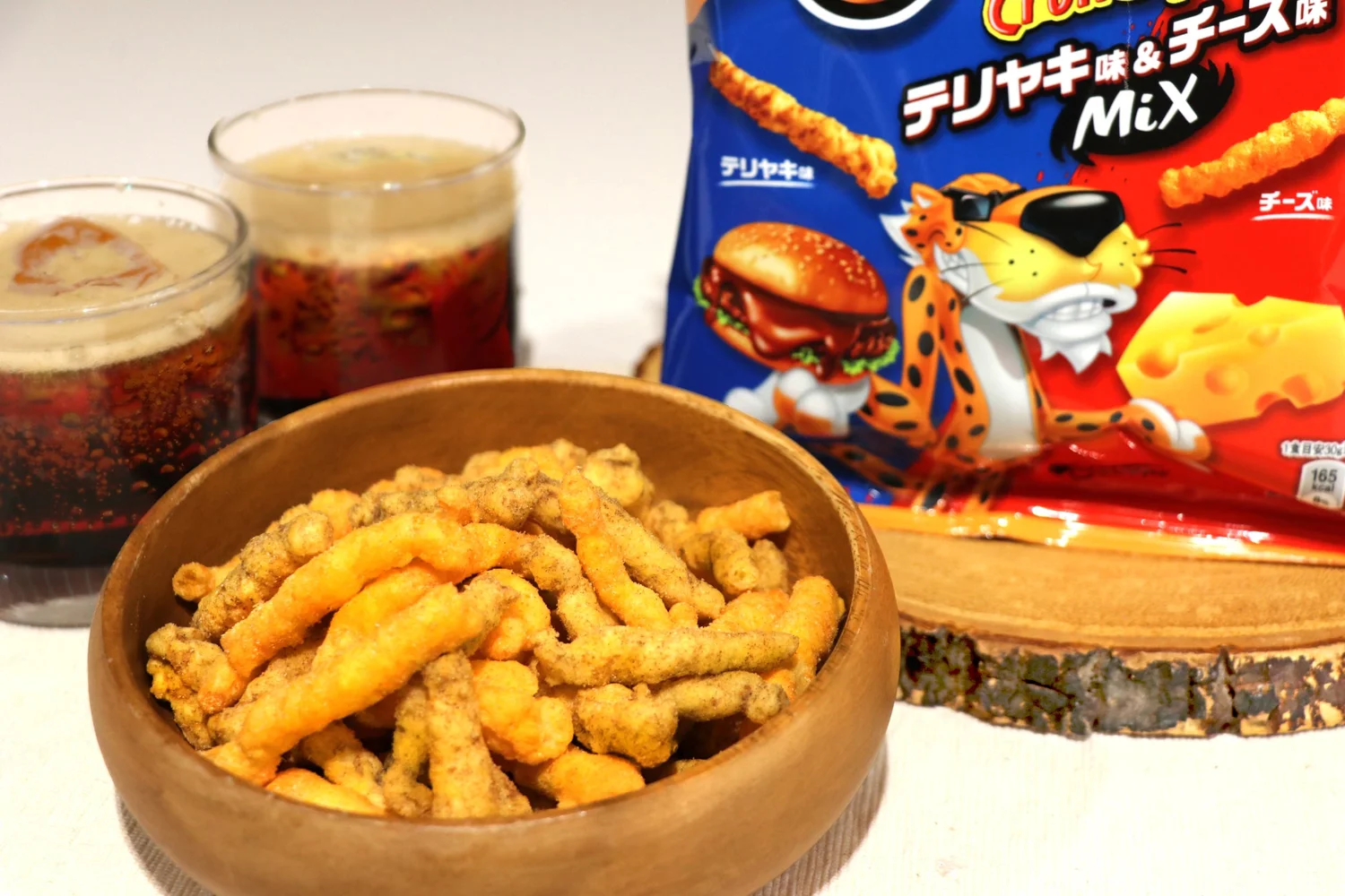 A mix of cheese and teriyaki flavored Cheetos in a bowl.
